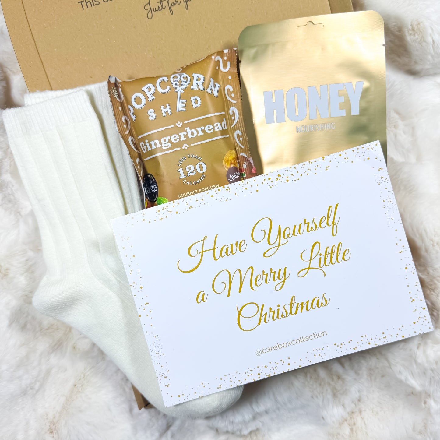 Gift set with popcorn and honey, featuring a card that says 'Have Yourself a Merry Little Christmas'.
