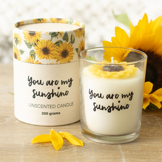 Candle with 'You are my sunshine' text and sunflower design on packaging