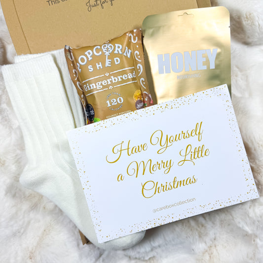 Gift set with popcorn and honey, featuring a card that says 'Have Yourself a Merry Little Christmas'.