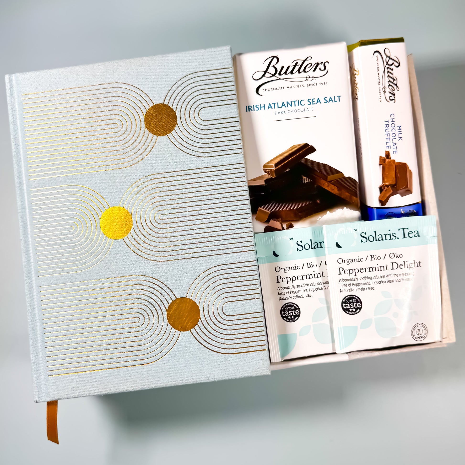 Tea, Treats & Thoughts gift box with notebook, peppermint tea, dark chocolate, and milk chocolate truffles. Perfect corporate gift ireland or onboarding gift