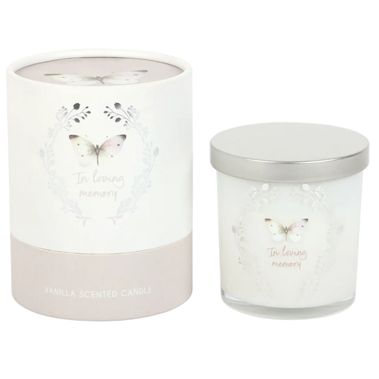 A white vanilla scented memorial candle with an “In Loving Memory” butterfly design beside its matching grey gift box 