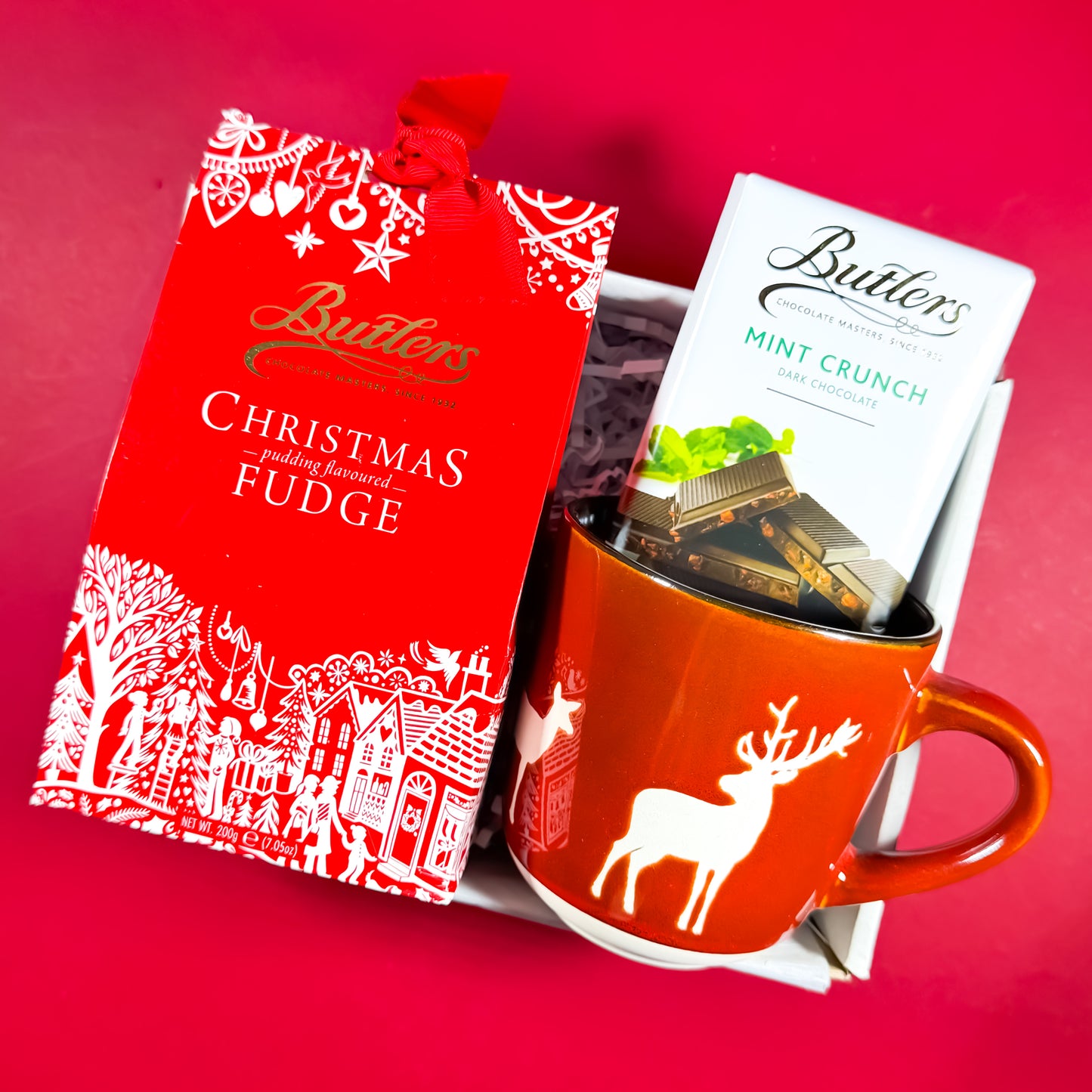 Sweet Season Christmas gift box featuring Butlers Christmas Pudding Fudge, Mint Crunch chocolate, and a red reindeer mug, festive Irish gift set from Care Box Collection