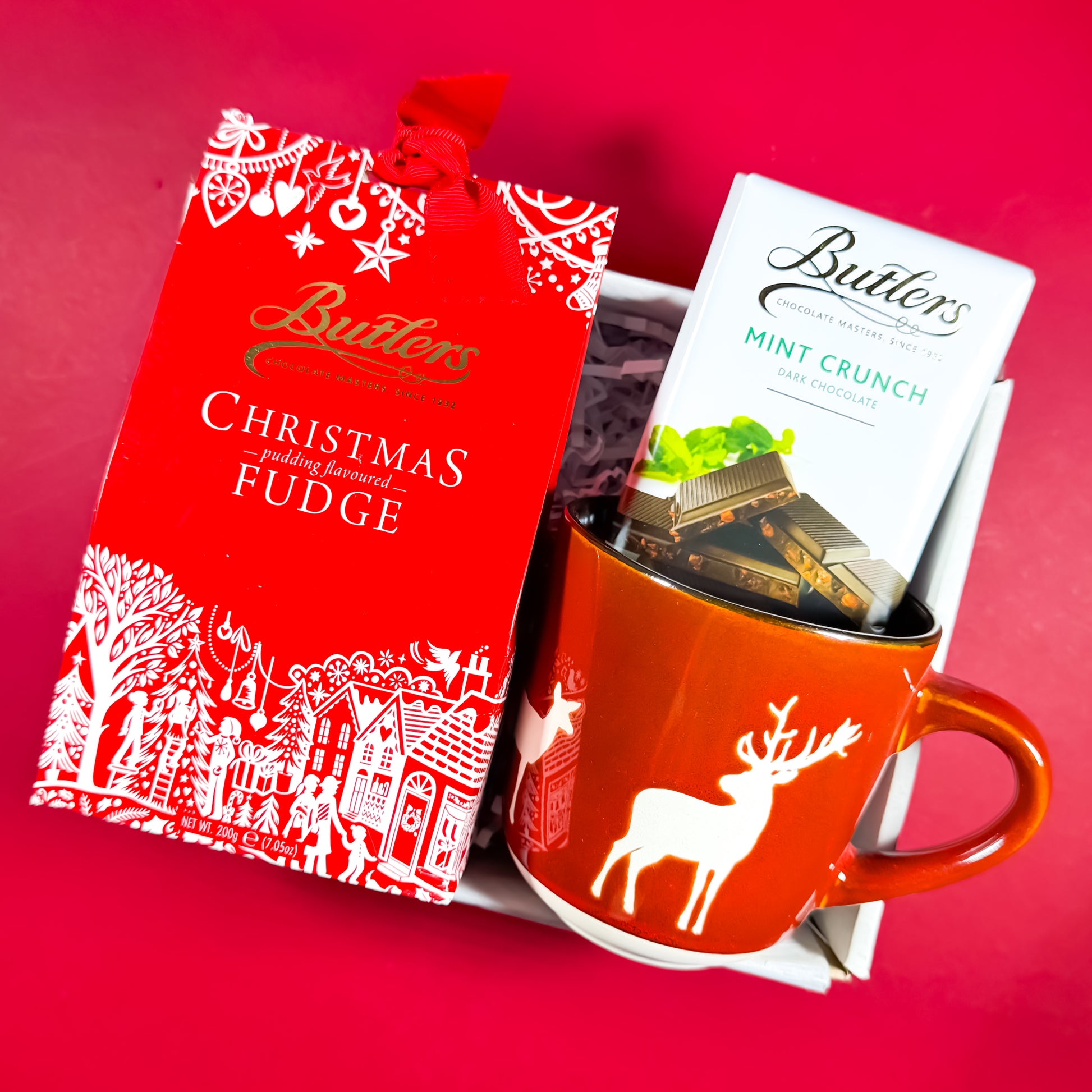 Sweet Season Christmas gift box featuring Butlers Christmas Pudding Fudge, Mint Crunch chocolate, and a red reindeer mug, festive Irish gift set from Care Box Collection