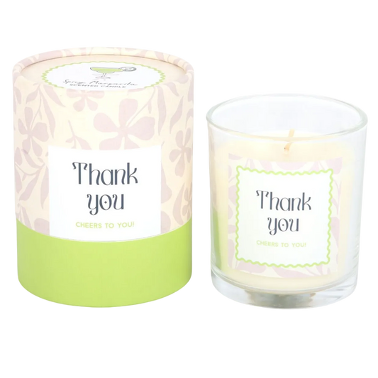 Candle with 'Thank you' label and matching packaging on a white background